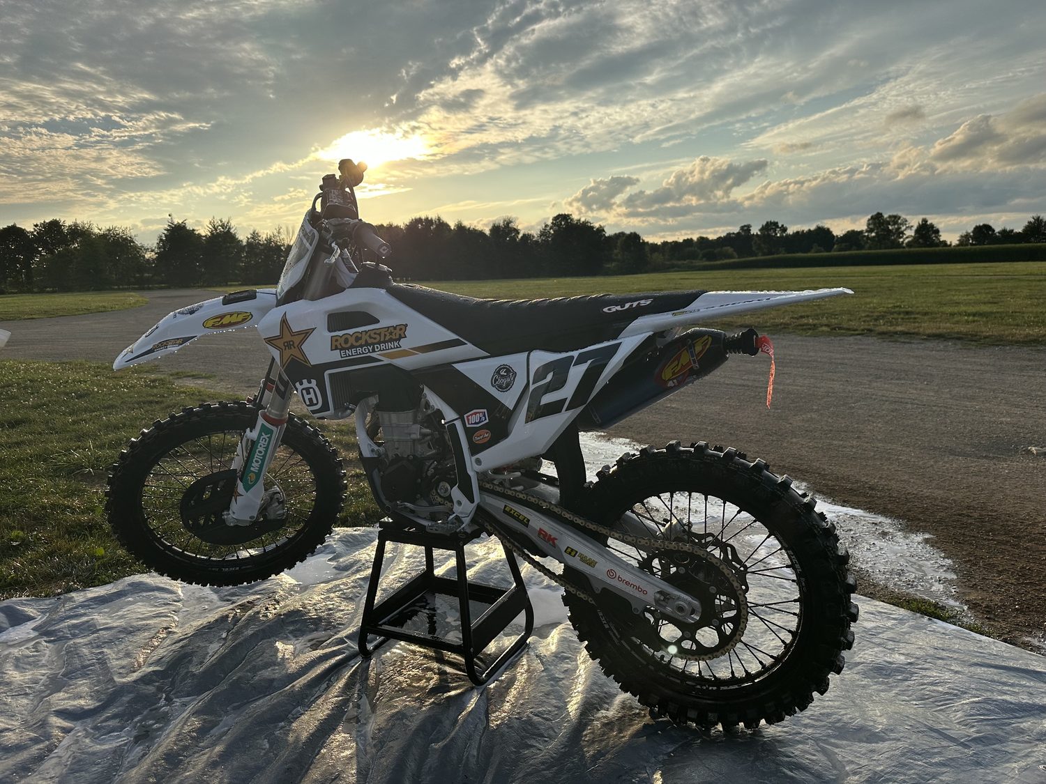 The same motocross bike rinsed to a clean, spot-free finish at sunset