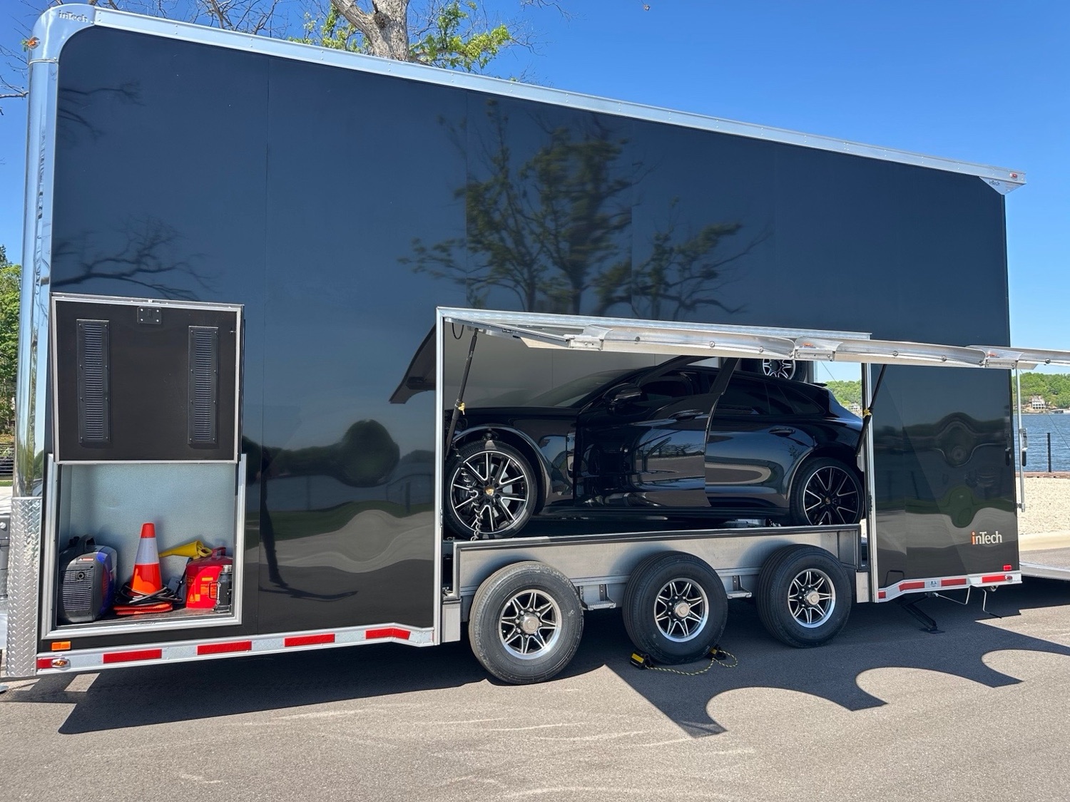Black Porsche loaded inside an inTech enclosed stacker trailer