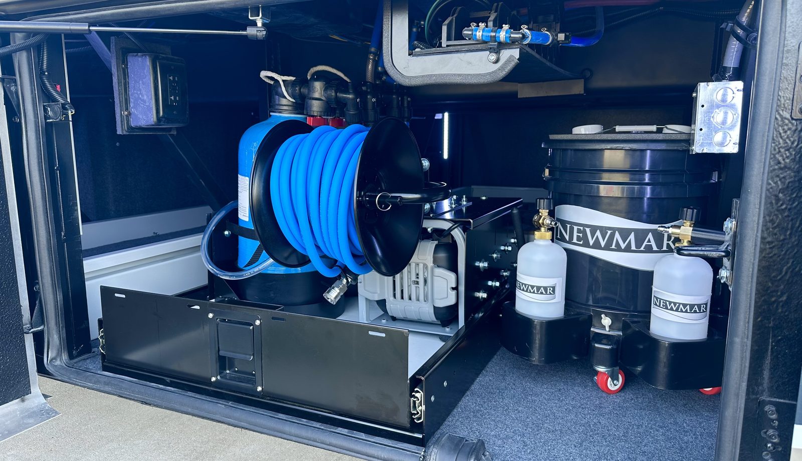 The complete H2O Simplified system, softener, advanced filtration, pump and spot-free rinse reel, built into the bay of a Newmar luxury motorhome